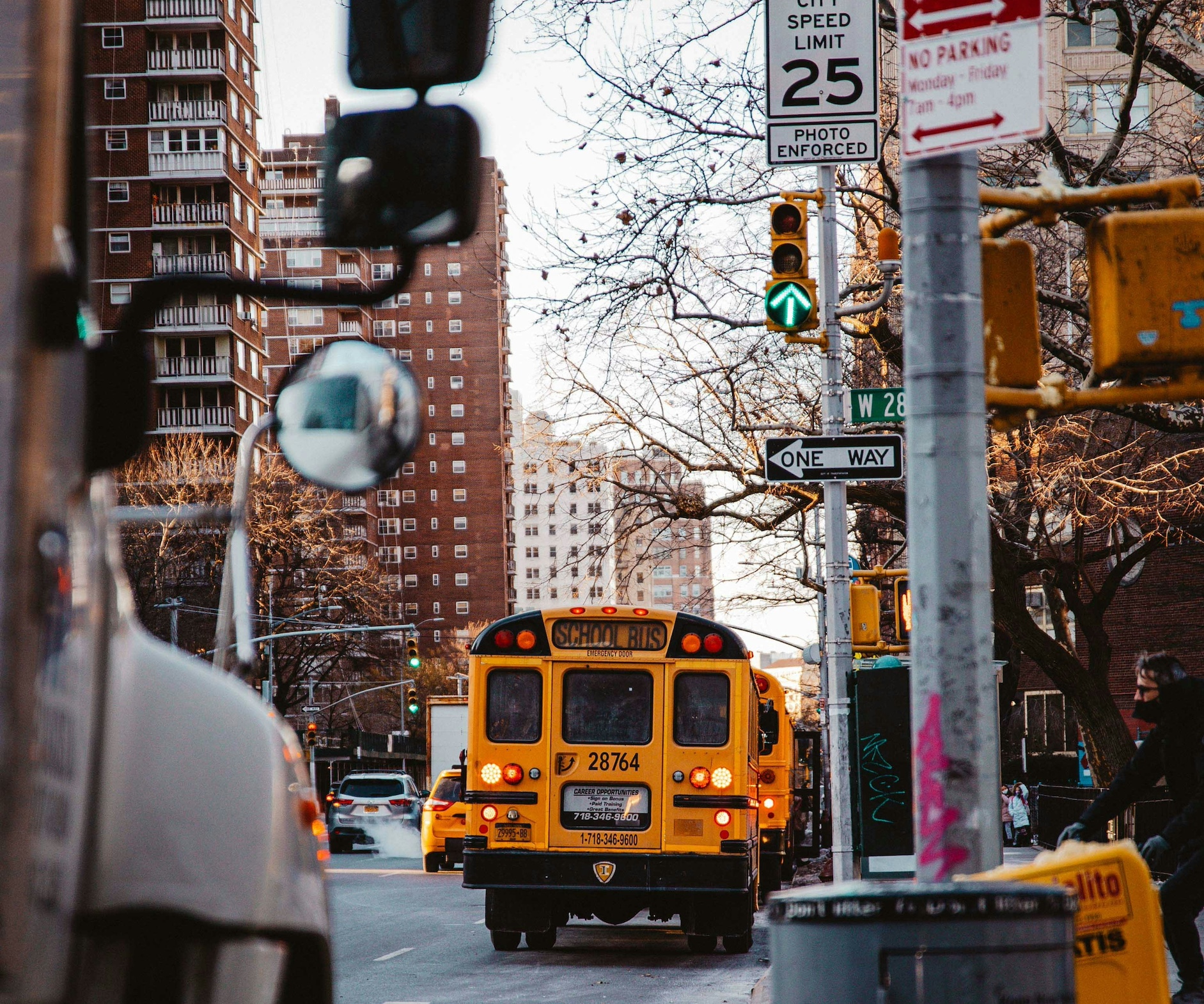 New York City school bus dropping off students at a school.